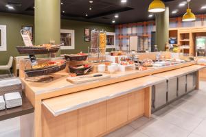 a buffet line with food on display in a restaurant at easyHotel Nice Old Town in Nice