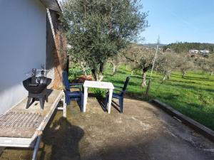 a table and chairs sitting next to a building at Casa Alfredo in Cavalinho