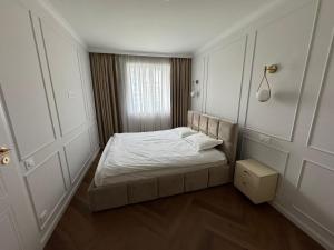 a small bedroom with a bed and a window at High Stay Suite Cluj in Floreşti
