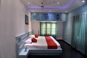 a bedroom with a bed with red pillows at Natures Bliss in Anaviratty