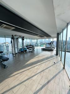 a gym on the floor of a building at The Prim Grand Condo Wongamat N103 - Spacious apartment near the sea in Pattaya North