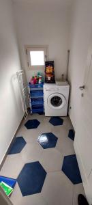 a small laundry room with a washer and dryer at Appartamento Luigia Finalborgo bike room tour ebike trekking in Finale Ligure