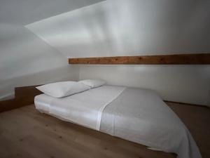 a white bed with two pillows in a room at Amanda C in Starigrad