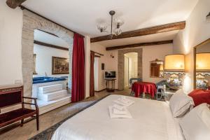 A bed or beds in a room at Corte Cristina & Suites