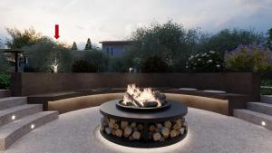 a fire pit in the middle of a garden at Casa dei fiori in Asprovalta