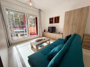 salon z niebieską kanapą i stołem w obiekcie Suite Maimonides Fuengirola w mieście Fuengirola