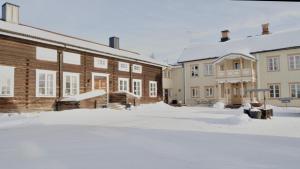 a group of buildings with snow on the ground at Gästis Lodge Vemdalen in Vemdalen