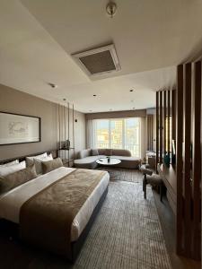 a bedroom with a large bed and a living room at Cityloft 147 in Istanbul +76 photos