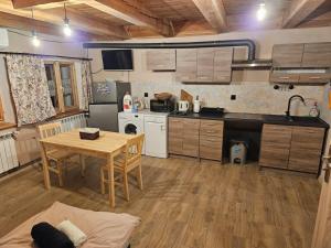 kuchnia z drewnianym stołem, stołem i krzesłami w obiekcie Apartament Rynek 30 w mieście Osieczna +16 zdjęć