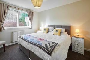 a bedroom with a large bed and a window at Host & Stay - Audrey's Cottage in Kirk Yetholm +13 photos