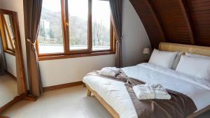 a bedroom with a bed with towels on it at Exclusive Hill Sapanca in Sapanca
