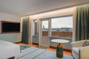 a living room with a view of a city at Sheraton Stockholm Hotel in Stockholm