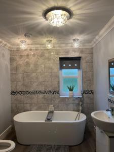 a bathroom with a large tub and a sink at Gellyburn Cottage in Kinross +102 photos