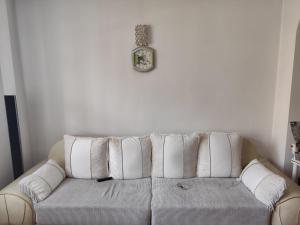 a white couch with white pillows in a living room at Vila Elena in Bucharest