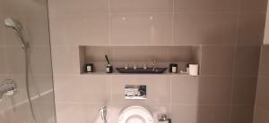a bathroom with a shower and a toilet and a sink at almoaj ,juman 2 marina view,level3 in Muscat +13 photos