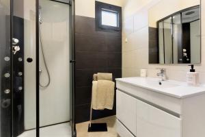 a bathroom with a sink and a shower at Casa da Pontinha in Machico +24 photos