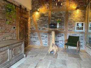 a room with a wooden wall with a chair and a table at Uriges Landhaus in der Natur in Dorsten