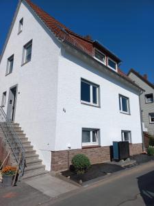 a white house with a staircase in front of it at Dalhausen, Am Schönste Aussicht in Beverungen +12 photos