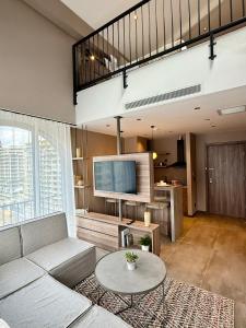 a living room with a couch and a tv at Cityloft 147 in Istanbul +75 photos