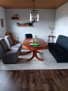 a living room with a table and a couch at Dalhausen, Am Schönste Aussicht in Beverungen