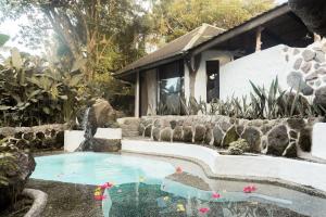 a swimming pool in front of a house at Balihao Resort in Mambajao