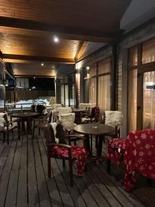 a room with tables and chairs and tablesearcher at The Lodge Hotel in Borovets