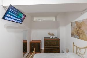 a bedroom with a bed and a tv on the ceiling at Borghetto Nora 3 in Gravina di Catania