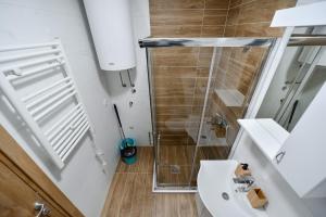 a bathroom with a shower and a white sink at Gorski Elegance 2 in Zlatibor +43 photos