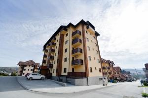 a building with a car parked in front of it at Gorski Elegance 2 in Zlatibor