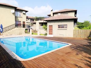 a swimming pool in front of a house at Elephant Villa Private Room in Nelspruit