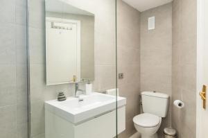 a white bathroom with a sink and a toilet at Beach and View Arguineguin MG by VillaGranCanaria in Arguineguín +46 photos