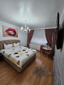 a bedroom with a large bed and a chandelier at CHIC Studio- Place to Remember in Galaţi