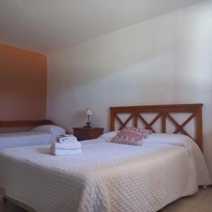 Postel nebo postele na pokoji v ubytování Aparthotel Agave