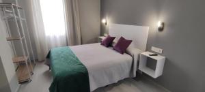 Posteľ alebo postele v izbe v ubytovaní Apartamentos Harmonia