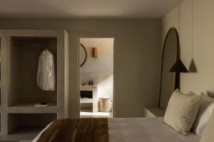 a bedroom with a bed and a dress hanging on a wall at Spioenkop Wines Farm House in Elgin +21 photos