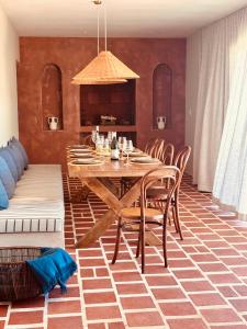 a dining room with a wooden table and chairs at Spioenkop Wines Farm House in Elgin