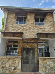 a brick house with a gate in front of it at Amoy Lane Hostel Penang in George Town
