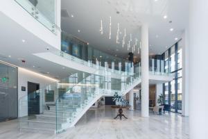 a staircase in a building with a person on the floor at Blue Star Luxury Hotel in Sofia