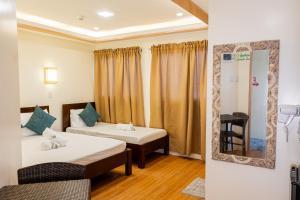 Ένα ή περισσότερα κρεβάτια σε δωμάτιο στο Anahaw Seaside Inn