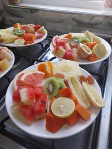 three plates of fruit on plates on a stove at Agnes Cottage in La Réunion +11 photos