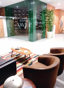 a lobby with chairs and a table in a building at The Surf Studio - Ericeira in Ericeira