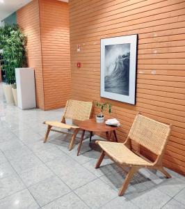 a table and two chairs and a table and a picture at The Surf Studio - Ericeira in Ericeira