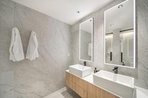 Un baño con dos lavabos y un espejo. en Allure 505 apts, en Bridgetown