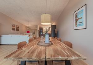 a dining room with a wooden table and chairs at By The Sea - Boathouse with Hot Tub & Parking in Vestmanna +15 photos