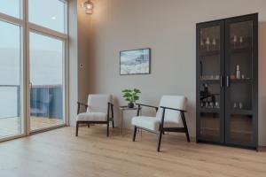 a living room with a table and two chairs at By The Sea - Boathouse with Hot Tub & Parking in Vestmanna