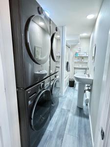 a bathroom with a sink and a mirror at 5BR Waterfront Hot Tub Kids Playscape Pets Family Compound! in Gouldsboro