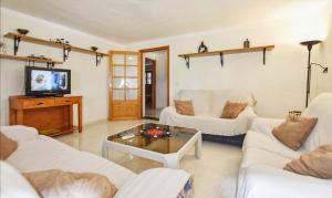 a living room with white furniture and a tv at Finca Son Cladera Petit in Son Macia