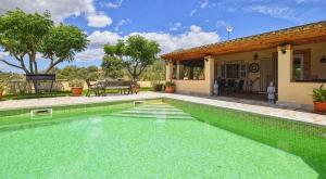 a swimming pool in front of a house at Finca Son Cladera Petit in Son Macia