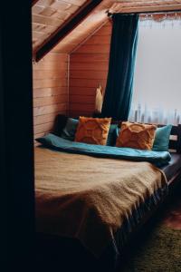 a bedroom with a large bed with a window at Forest hugs котедж Славсько з джакузі in Khashchovanoye +70 photos
