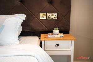 a bedroom with a bed and a nightstand with a plant on it at The Segond Hotel in Xagħra